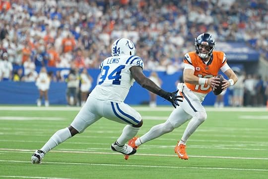 Broncos quarterback Bo Nix escapes the Colts pass rush.