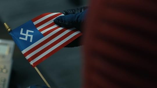 A tiny American flag with a white swastika instead of stars on Peacemaker