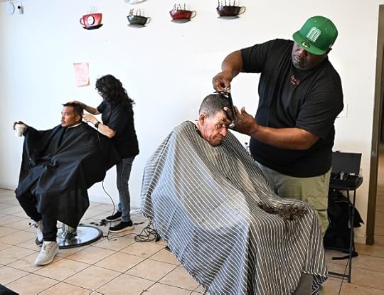 Jeff Glough gets a free haircut from Kareem Hickman, from Liberty Church, during Dignity Day at the Solano Dream Center on Saturday in Vallejo. (Chris Riley/Times-Herald)