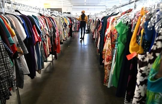 Mercedes Miller looks for a cute outfit in the long aisles of clothing at the newly reopened Opportunity House thrift shop in Vacaville on Peabody Road. (Chris Riley/The Reporter)