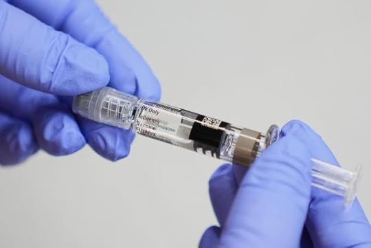 Clinic support supervisor May Fengmei Lin, CMA, displays a syringe of the Fluarix flu vaccine at International Community Health Services, Wednesday, Sept. 10, 2025, in Seattle. (AP Photo/Lindsey Wasson)
