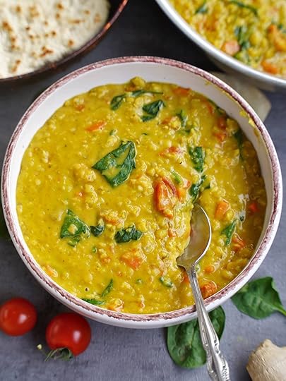 top shot yellow lentil dal with spoon