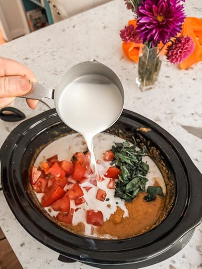 Adding in the whole milk to the slow cooker