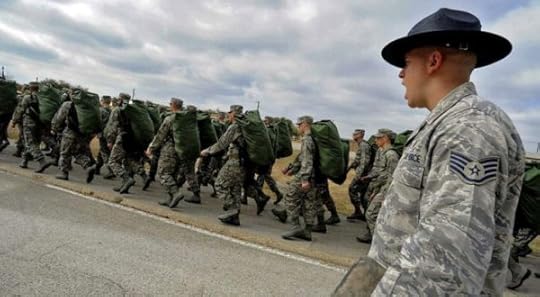 Staff Sgt. Robert George, a military training instructor at Lackland Air Force Base, Texas, marches his recruits following the issuance of uniforms and gear during basic training. (Master Sgt. Cecilio Ricardo / Air Force)