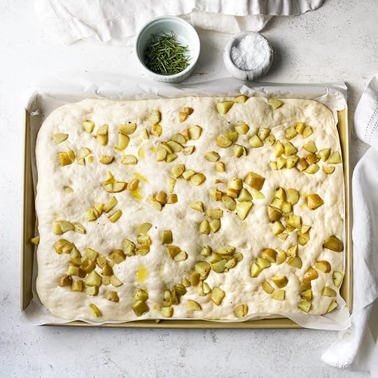 Small diced potatoes on top of puffy focaccia bread.