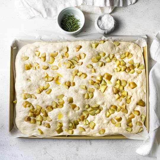 Puffy focaccia with potatoes dotting the top.