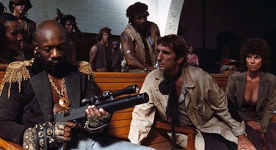 Isaac Hayes looks down at the gun in his hands while Harry Dean Stanton watches him in