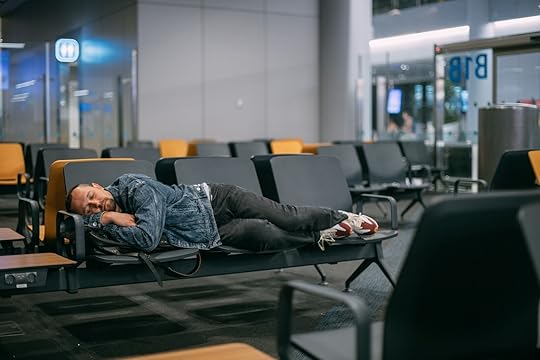 most connected airports in the us - guy sleeping in terminal