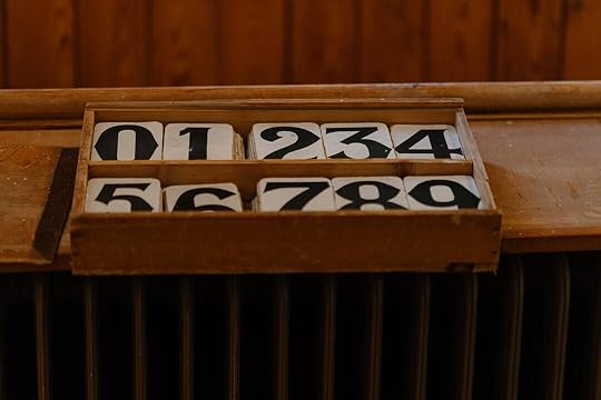 A close up of a wooden box with numbers on it