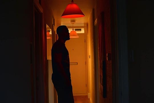 a man standing in a hallway at night