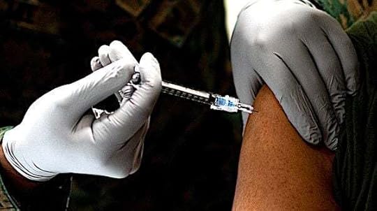 A U.S. Navy corpsman administers a U.S. Marine with the Pfizer-BioNTech COVID-19 vaccine on Camp Lejeune, North Carolina, Jan. 15, 2021. (U.S. Marine Corps photo by Cpl. Rachel K. Young-Porter)