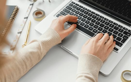 woman typing on a laptop