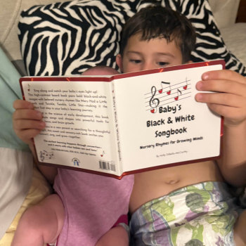 children reading baby's black and white songbook