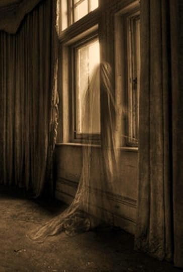 This may contain: a woman standing in front of a window with curtains on the windowsill and her dress blowing in the wind