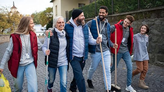 mixed group of adults holding cleaning tools