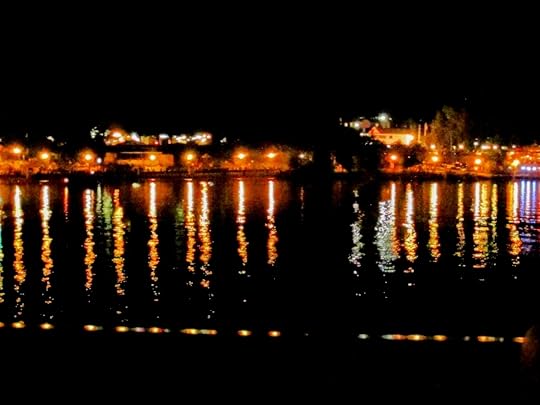 multi-colored lights distorted in reflection on a river