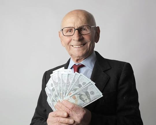 Smiling man in a suit holding U.S. dollar bills, representing manifestation quotes for money