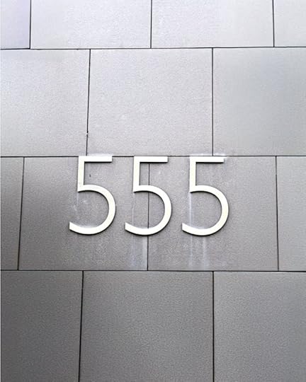 Large “555” numerals on a gray tiled wall linked to manifestation quotes for money