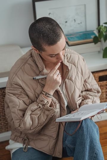 Person drafting affirmations in a notebook before creating cards—how to make affirmation cards