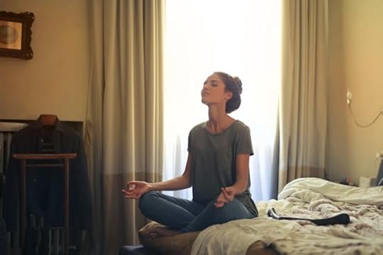 Woman meditating in a calm bedroom while finding her purpose and passion