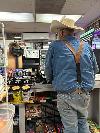 man in cowboy hat at convenience stoor