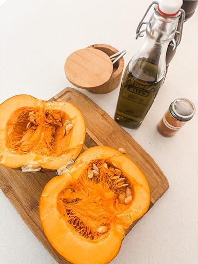 The ingredients for the Oven-Roasted Pumpkin, including the pumpkin cut in half