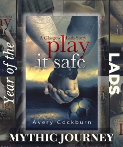 Text: “Year of the Lads” and “Mythic Journey” Image: Book cover: Book cover: Play It Safe: A Glasgow Lads story by Avery Cockburn. Image of two men holding hands visible from forearm down. A soccer ball appears in the foreground, and the background is a sky with bright sunshine beneath heavy clouds over distant hills.