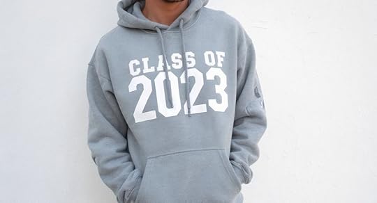 Person wearing a gray hoodie with 'CLASS OF 2023' printed in white on the front, standing against a plain background.