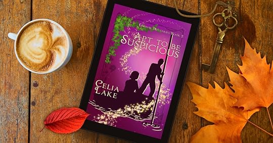 The cover of Apt to be Suspicious on a wooden table with a mug of coffee, a key, and two bright leaves, red and orange. The cover is a deep wine-purple, with a silhouetted man and woman. He is pushing a punt with a pole, and they are framed by ivy and a swirl of stars. 