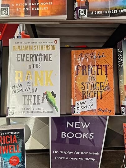 Paperback books on a display shelf. Everyone in This Bank is a Thief by Benjamin Stevenson and Fright on Stage Right by G. B. Ralph.