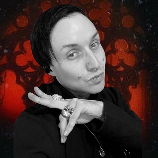 The author is a young white man with dark hair and facial piercings making a peace sign gesture with his right hand, featuring multiple rings, in front of a dark, ornate Gothic cloisters background with red hues.