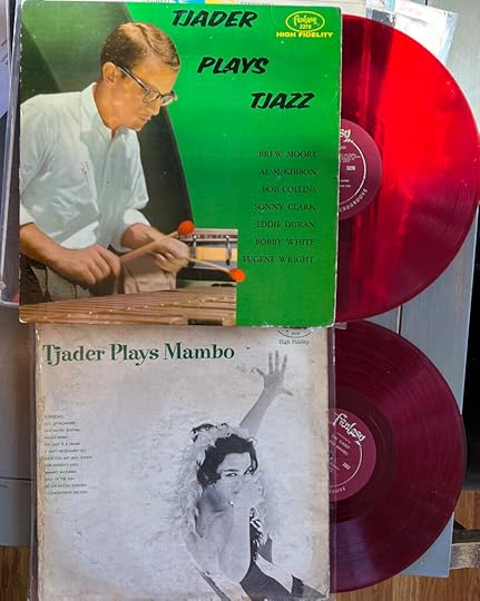 Photo of two red vinyl records, half-emerged from their sleeves: TJADER PLAYS TJAZZ (1954) and TJADER PLAYS MAMBO (1956).