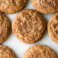 Soft and chewy dirty chai snickerdoodle cookies with warm spice sugar coating on a white marble surface.