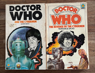 First edition paperbacks of Doctor Who and the Cybermen and Doctor Who The Revenge of the Cybermen, artwork by Chris Achilleos showing Doctor Who and the Cybermen