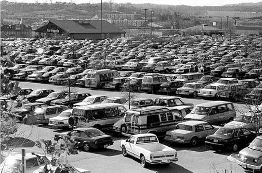 A crowded parking lot filled with cars, capturing the hectic atmosphere typically associated with Black Friday shopping.