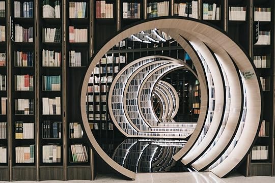 brown wooden book shelves in a library