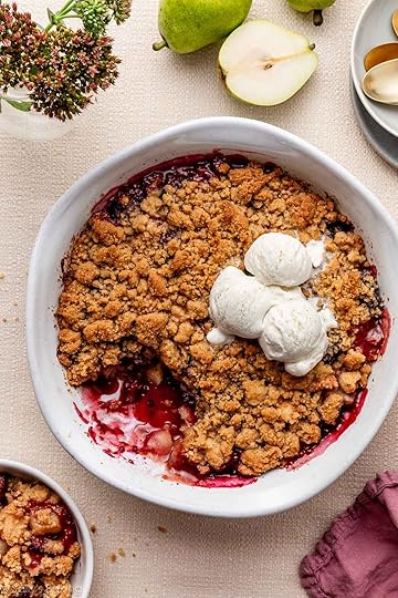pear berry crumble in white serving dish with vanilla ice cream.