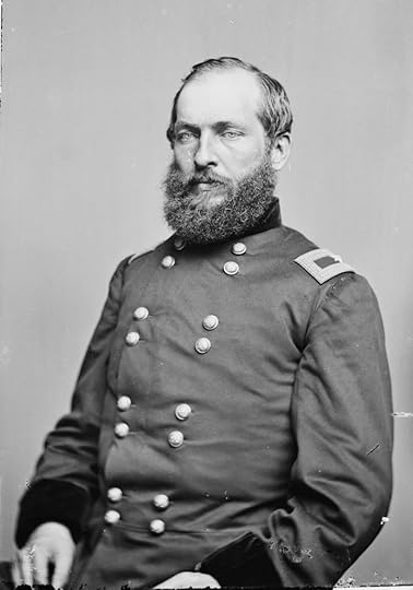 Portrait of a bearded man wearing a Civil War-era military uniform adorned with buttons and epaulets.