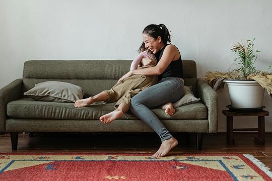 behaviourist parenting and neurodivergent children photo of woman sitting on couch while hugging her child