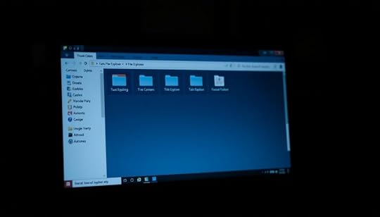 A dimly lit desktop computer screen, with a file explorer window prominently displayed. The window reveals several folders, some of which appear hidden, their icons slightly faded and their names obscured by spaces. The background is slightly blurred, creating a sense of depth and focus on the file explorer. The lighting is soft and moody, casting subtle shadows across the screen. The overall atmosphere is one of mystery and secrecy, suggesting the ability to conceal sensitive information within the computer's file system.