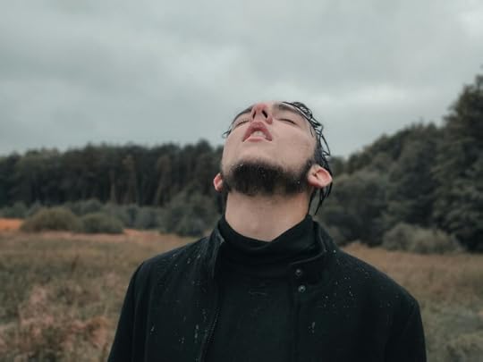 A man looking uncomfortable under a cloudy sky. Your comfort zone might be a lie.
