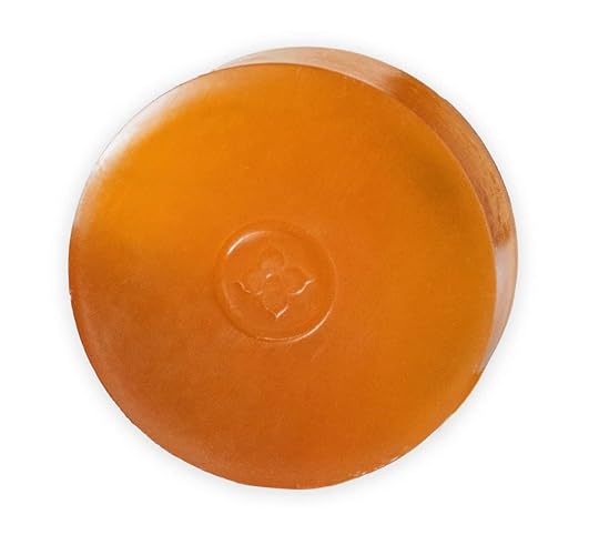 A closeup of a Mirai persimmon soap bar, an orange bar of soap.