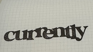 "Currently" stamped into a notebook