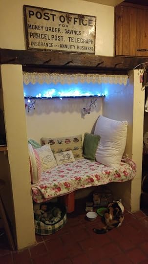 Photo of inglenook bench seat with cushions, fairy lights, etc