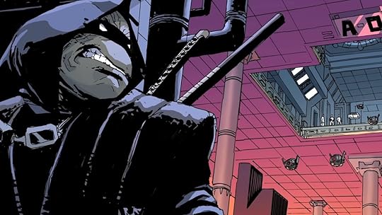 A page from TMNT: The Last ROnin comic featuring the Ninja Turtle in a black mask and hood hiding behind a wall in a large factory room