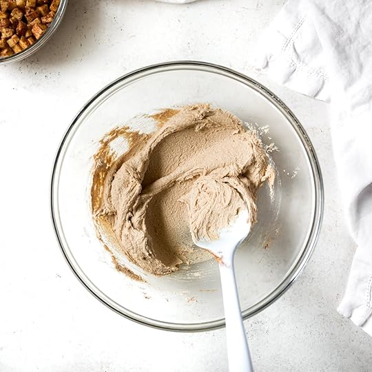 Close-up overhead view of creamed butter and sugar and spices that have been whipped until light and fluffy and smooth.