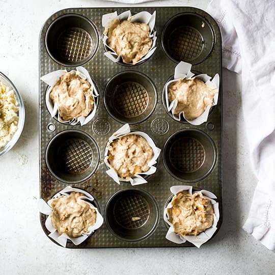 Lined muffin tin filled with muffin batter.
