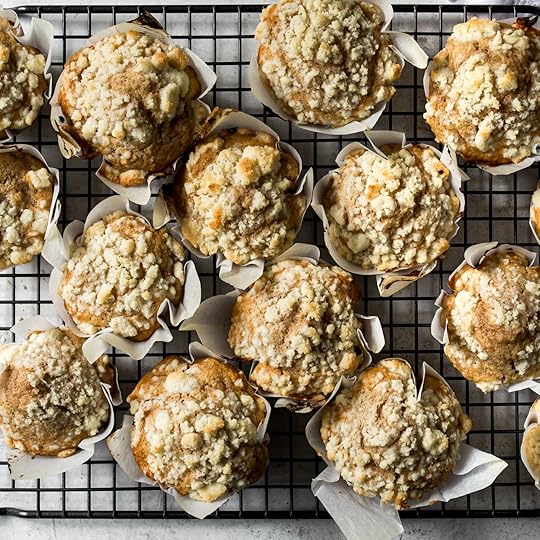 Fresh baked apple muffins cooling on a wire rack.