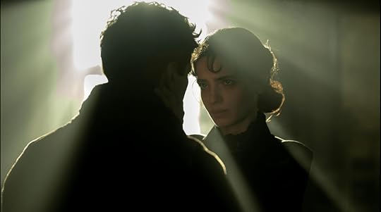 Light pours through the window and is blocked by Ziya (the light who blocks the light, which is part of a prophecy about him), and illuminates Ayise, played by Sifanur Gül. Both are in mourning dress. 