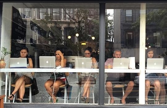 Freelancers working on computers in cafe.
